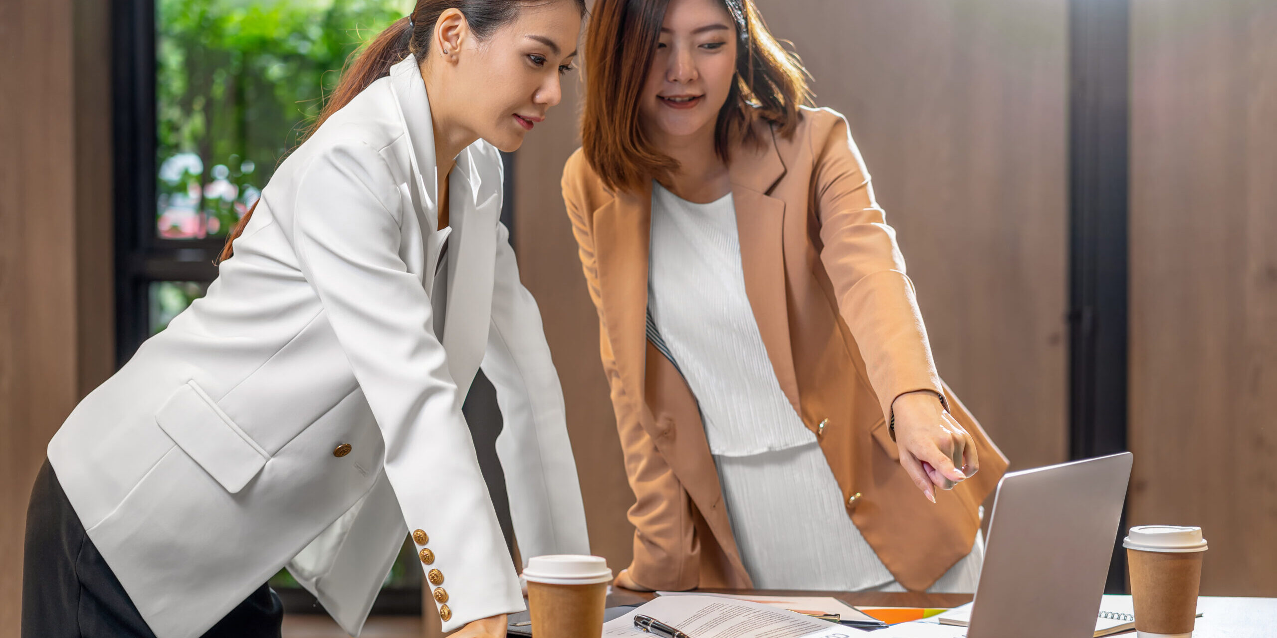 Two asian businesswomen working with the partner business via te