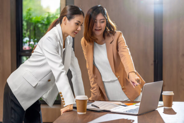 Two asian businesswomen working with the partner business via te